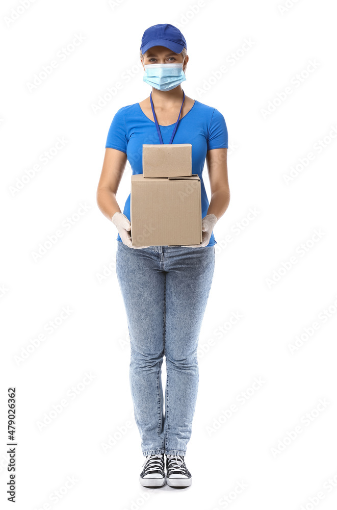 Female courier in medical mask and with parcels on white background