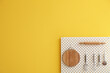 © Pixel-Shot - Peg board with kitchenware hanging on yellow wall