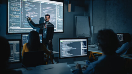 Fototapete - Teacher Giving Computer Science Lecture to Diverse Multiethnic Group of Female and Male Students in Dark College Room. Projecting Slideshow with Programming Code. Explaining Information Technology.