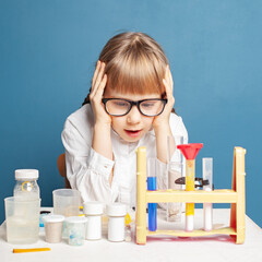 Wall Mural - Small child girl making experiment. Research, education and science in modern school