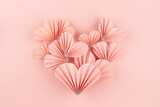 Fototapeta Mapy - Simple elegant pink paper heart of flying little ribbed hearts on cute pink color - Valentine day background, top view, copy space. Fun love backdrop for flyer, card, poster, design, advertising.