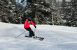 Female skier on a slope in the mountains on a beautiful sunny winter day.