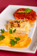 Wall Mural - A Trio of Large Ravioli on a plate with three types of sauce.