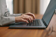 © Georgii - Female hands typing on computer keyboard study or work with laptop software tech. Online job or education, close up