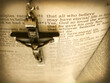 This sepia toned photo of an antique Italian handmade cross hanging over the Bible verse John 3:16 
