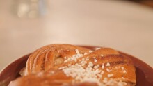 Safran Bulle Bun In White Plate From A Bakery, Traditional Delicacy In Stockholm, Sweden.