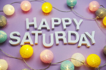 Wall Mural - happy saturday alphabet letters with led cotton balls on purple background