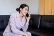 © Abdul - woman sitting on the sofa talking on the phone happily