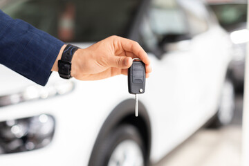 Wall Mural - Businessman hand with key from brand new auto, closeup