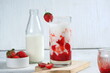 a glass of korean strawberry milk and berries.bright mood,white background.