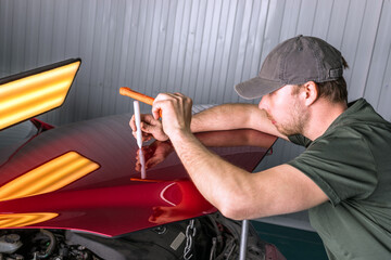 Wall Mural - Removing dents on a car body without painting. PDR.