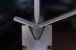 © Yaroslav - Bending of sheet metal parts using a bending machine. Production of metal parts.