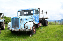 Rusty Old Truck On Meadow. Abandoned Blue Car In Nature. Vintage Farm Truck On The Field.
