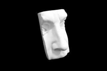 Wall Mural - Fragment of plaster sculpture of a human face isolated on black background