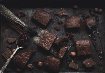 Canvas Print - pieces of baked chocolate brownie pie in a metal baking sheet on a black table