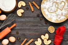 Valentine's Day Baking Culinary Background. Ingredients For Cooking -whisk, Eggs, Cinnamon Sticks, Star Anise, Flour, Napkin On Wooden Kitchen Table. Baking Recipe For Pastry. 