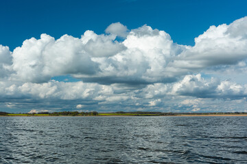 Wall Mural - cloudy landscape in the lake and the sea with kayaks