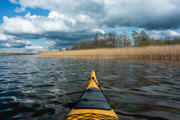 Wall Mural - cloudy landscape in the lake and the sea with kayaks