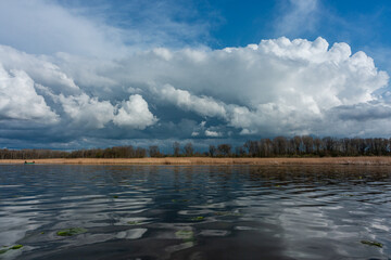 Wall Mural - cloudy landscape in the lake and the sea with kayaks