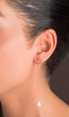 Designer earrings on a young female photo model. hand made