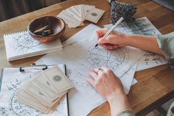 astrology. astrologer calculates natal chart and makes a forecast of fate tarot cards, fortune telli