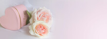 Blurred Bokeh Valentine's Day Background With Candle Lights,roses And A Pink Heart-shaped Box