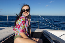 Young Woman Wearing Sunglasses On A Sailboat Cruise Over The Caribbean Sea During A Tropical Vacation