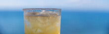 Ice Cold Margarita With Tequila, Lime Juice And A Salted Rim In A Glass With An Ocean Front View. A Refreshing Drink With Alcohol During A Tropical Island Vacation. 