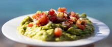 Plate Of Guacamole Topped With Pico De Gallo Made Fresh From Avocado And Tomato In Mexico. Served As An Appetizer During Travel To Cozumel. 