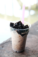 Grass jelly with fresh milk in cafe and bakery handmade shop. Delicious and sweet dessert In Thailand