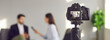 © Studio Romantic - Blurry copy space banner background with a closeup shot of a modern video camera with a digital display recording an interview in a TV show studio. Mass media, television, and technology concepts