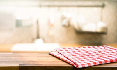 Wall Mural - Red fabric,cloth on wood table top on blur kitchen counter (room)background.