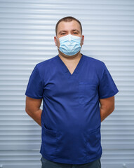 Wall Mural - Portrait of professional medical specialist in uniform. Confident doctor in mask.