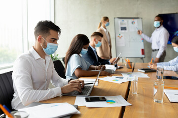 Poster - Group Of Multiethnic Colleagues Wearing Medical Masks Having Business Meeting In Office