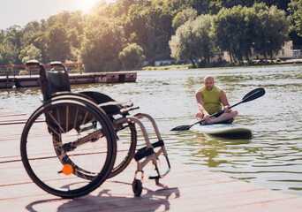 Wall Mural - Person with a physical disability ride on sup board