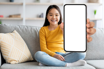 Happy pretty asian girl showing smartphone with empty screen