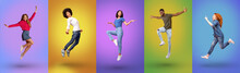Full Length Of Millennial International People Jumping Together, Smiling At Camera Over Bright Neon Studio Backgrounds