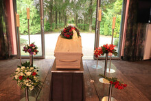 A Coffin With A Flower Arrangement In A Morgue
