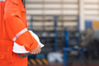© Nattawit - A worker is holding white safety helmet with blurred background of mechanical workshop area. Industrial safe working concept. Close-up and selective focus at people's hand.