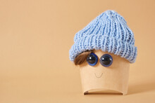 Cardboard Packaging For French Fries Or Other Fast Food Product With A Smile And Doll Eyes And In A Knitted Hat
