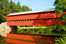 The Red Sachs Covered Bridge, Crosses A Small Stream Gettysburg, Pennsylvania Creating A Reflection In The Water