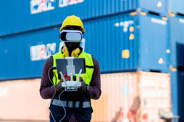 Foreman or worker use remote controller piloting drone at containers port for checking container. Foreman use remote control Drone with camera flying on container cargo ship at shipping port.