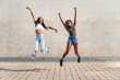 © Raul Mellado - two young black women jumping happy