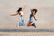 © Raul Mellado - two young african girls jumping happy