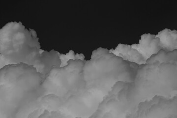 Wall Mural - clouds over black background .