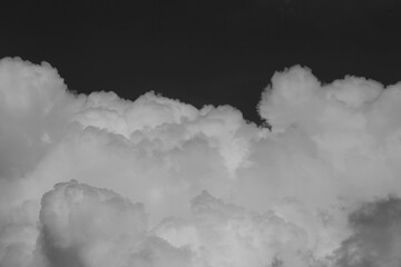 Wall Mural - clouds over black background .