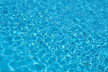 Closeup Surface Of Blue Clear Water With Small Ripple Waves In Swimming Pool