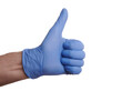 Thumb up hand gesture in blue nitrile glove. Nitrile gloved hand shows thumb up success gesture. Photo of medic gloved hand isolated on a white background. Positive gesture of medic hand. Blue nitrile