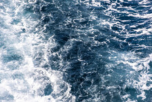 Top Down Aerial View Of Sea Water Surface. White Foam Waves Texture As Natural Background.