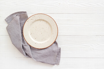 Wall Mural - Table setting top view. Empty plate on napkin - dishware for dinner